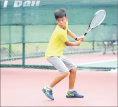  ??  ?? Tan Lin En of Malaysia returns a shot to Mitsuki Leong Wei Kang in the semi-finals of the boys singles yesterday. Tan won 6-2, 7-5 to set up an all-Malaysian final with Leroy Yong. — Photos by Chai Chang Yu