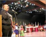  ??  ?? Armenian chairperso­n Rafi Topalian of Watervliet sings the national anthem during The 45th annual Festival of Nations, held Sunday afternoon at the Empire State Plaza Convention Center in Albany.