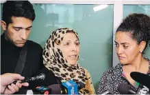  ??  ?? Kobra Mohammadi, centre, mother of victim Maryam Rashidi, and her son, Mohamad Rashidi, speak to reporters with the help of a translator after Wednesday’s sentencing in Calgary.