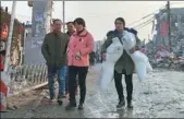  ?? WANG JING / CHINA DAILY ?? A business owner transports mannequins on Tuesday in Xinjian village of Beijing’s Daxing district, as the village demolishes illegal buildings in the wake of a deadly fire that claimed 19 lives on Saturday.