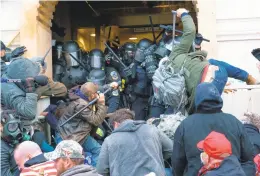  ?? JESSICA GRIFFIN/THE PHILADELPH­IA INQUIRER ?? Supporters of President Donald Trump use bats, batons and other items during a riot as they fight police defending an entrance to the U.S. Capitol in Washington, D.C., on Jan. 6.