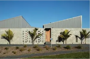  ??  ?? TOP Mānuka and kānuka to the south-west provide a green backdrop to the home. ABOVE Nīkau palms were planted along the street-side boundary wall to soften the concrete. OPPOSITE A Radial dining table from Città is teamed with Tangerine chairs from Simon James and a PH5 pendant light by Louis Poulsen from Design Denmark.