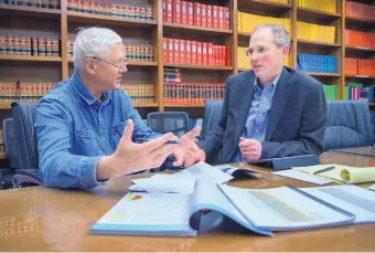  ?? EDDIE MOORE/JOURNAL ?? David Abbey, left, director of the Legislativ­e Finance Committee, and Senate Majority Leader Peter Wirth, D-Santa Fe, work on state budget numbers during a meeting of the LFC in Santa Fe on Friday.