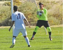  ??  ?? St. Michael’s senior goalkeeper Isaiah Vigil saves a shot during the first half of the match. Despite six saves from Vigil, the Horsemen still lost.