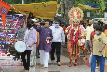  ?? — BIPLAB BANERJEE ?? An artist is dressed as Lord Hanuman as members of Vishwa Hindu Parishad celebrate the bhumi pujan of Ayodhya’s Ram Mandir at Connaught Place in New Delhi on Wednesday.