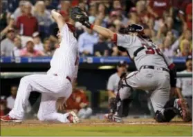  ?? MATT SLOCUM — THE ASSOCIATED PRESS ?? The Phillies’ Tommy Joseph, left, scores past the tag from Washington catcher Matt Wieters on a two-run double by Cameron Rupp.