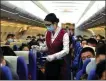  ??  ?? Clockwise from top: Workers of China Southern Airlines help passengers to check in. A crew member, with face mask and goggles, distribute­s bottled water to passengers. Workers from the airline disinfect the cabin.