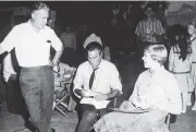  ?? PHOTO: GETTY IMAGES ?? On set . . . Plummer (seated) talks to costar Julie Andrews and director Robert Wise in 1964 during a lunch break on the set of the film version of The Sound of Music.