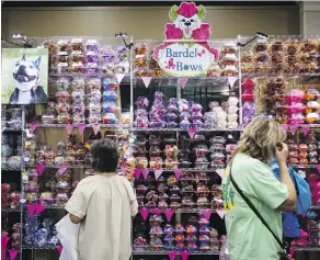  ??  ?? Dog groomers and owners browse accessorie­s at the Groom Expo.