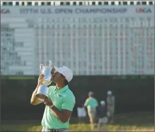  ?? The Associated Press ?? FIRST MAJOR WIN: Brooks Koepka kisses the winning trophy after the U.S. Open Sunday at Erin Hills in Erin, Wis. The 27-year-old Koepka grabbed control with three straight birdies on the back nine to finish at 16-under.