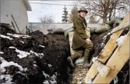  ?? The Canadian Press ?? Edmonton high school student Dylan Ferris stands in a trench he built in his backyard. Ferris is spending 24 hours in the muddy trench for a social studies project.