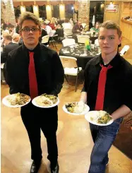  ?? MEGAN DAVIS MCDONALD COUNTY PRESS ?? MCHS Juniors, Grant Cooper and David Roark, were two of the culinary students who helped to cater the banquet. Students spent a week preparing the menu items for this event.