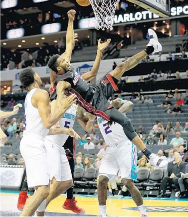  ?? STREETER LECKA/GETTY-AFP ?? Heat forward Derrick Jones Jr. takes a tumble to the floor during a scramble for a rebound in the second quarter Tuesday night.