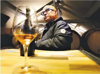  ??  ?? ERIC RODEZ, organic wine maker in Champagne, sits as he enjoys a glass of his vintage champagne in the vat room, of his champagne house in Ambonnay on Dec. 20, 2017. More and more vine growers turn their backs on phytosanit­ary products, and want to...