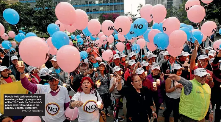  ?? PHOTO: REUTERS ?? People hold balloons during an event organised by supporters of the ‘‘No’’ vote for Colombia’s peace deal referendum in the capital, Bogota, yesterday.