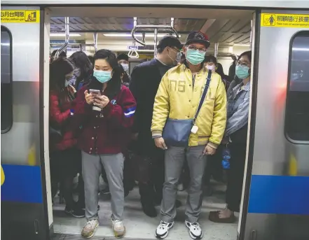  ?? PAULA BRONSTEIN / GETTY IMAGES ?? Commuters pack a metro train in downtown Taipei, Taiwan, which along with Singapore and Hong Kong has had more successful approaches in battling the pandemic given their experience with SARS in 2003.