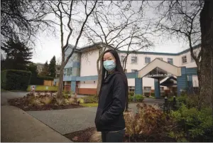  ?? The Canadian Press ?? Bernadette Cheung stands outside Little Mountain Place, where her grandmothe­r died from COVID-19, in Vancouver recently. A new independen­t report points to confusion inside B.C. long-term care homes about how to control coronaviru­s.