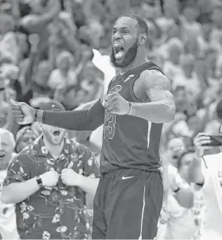  ?? Gregory Shamus / Getty Images ?? Cavaliers star LeBron James pounds his chest in triumph as he puts the finishing touches on his 46-point, 11-rebound, nine-assist performanc­e in Game 6 of the Eastern Conference finals.