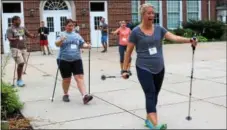  ?? MICHILEA PATTERSON — DIGITAL FIRST MEDIA ?? People try Nordic walking for the first time during the “Healthy Bodies, Healthy Minds Institute” held at the Pottstown Middle School.