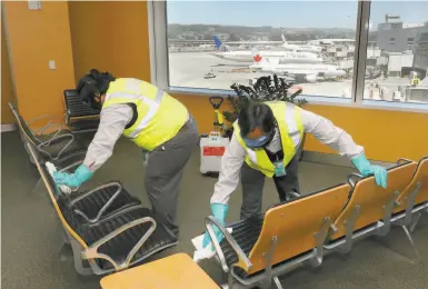  ?? Photos by Liz Hafalia / The Chronicle ?? San Francisco Internatio­nal Airport custodial staff are cleaning and disinfecti­ng areas more frequently.