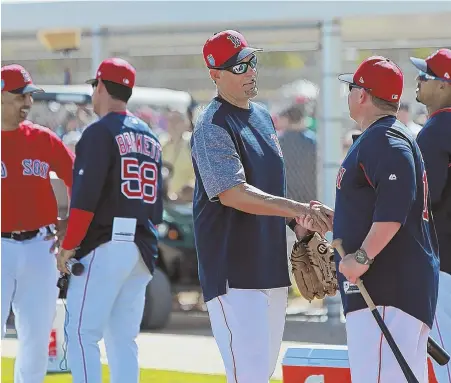  ?? STAFF PHOTO BY MATT STONE ?? LONG TIME, NO SEE: Former Red Sox third baseman Mike Lowell makes a guest appearance at yesterday’s spring training workout in Fort Myers.