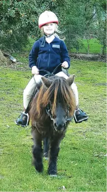  ??  ?? Back at one of her favourite pastimes, riding her pony, five year-old Verity Watkins has come a long way after early problems following a fall that fractured an elbow.