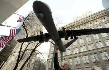  ?? Don Emmert, AFP/ Getty Images file ?? Demonstrat­ors hoist a model of a drone in the air as they protest the U. S. military’s use of the weapons during an “April Days of Action” demonstrat­ion in 2013 in New York.