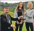  ??  ?? Councillor Roddy McCuish presents the trophy to Abbie Cato, with Katie Edmundson second.