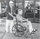  ?? MARK HENLE/THE REPUBLIC ?? Volunteer Lewis Payne wheels Ralph Brewer to his car at Banner Boswell Medical Center in Sun City. Payne is among 770 volunteers who help keep the hospital running.