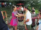  ?? QUAN SHU / FOR CHINA DAILY ?? A Miao woman welcomes a foreign visitor with local rituals.