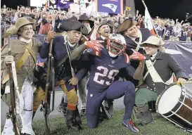  ?? CHARLES KRUPA/ASSOCIATED PRESS ?? Running back LeGarrette Blount has a good time with the End Zone Militia after scoring one of his two touchdowns for the Patriots in Thursday’s win over the Texans.