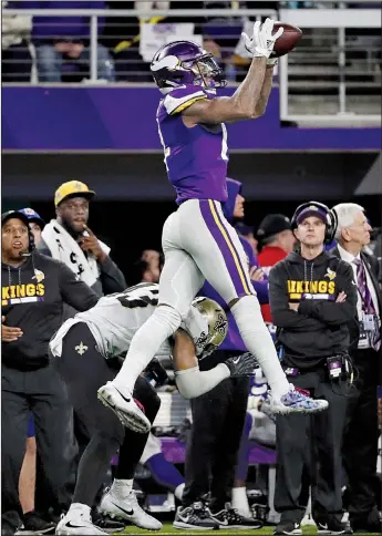  ?? AP/JEFF ROBERSON ?? ABOVE: Minnesota Vikings wide receiver Stefon Diggs makes a catch over New Orleans Saints free safety Marcus Williams on his way to the winning touchdown with no time left Sunday. The Vikings defeated the Saints 29-24 to advance to the NFC Championsh­ip Game. LEFT: Vikings quarterbac­k Case Keenum celebrates Minnesota’s victory.