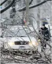  ?? Postmedia News/files ?? A police officer cordons off a downed power line and tree branches after the ice storm that hit Toronto last month.