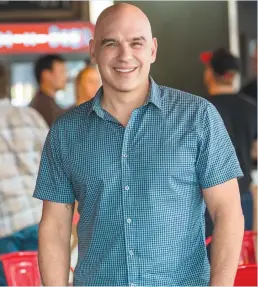  ??  ?? Michael Symon hosts “Burgers, Brew and ‘Que”