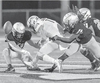  ?? MICHAEL LAUGHLIN/SOUTH FLORIDA SUN SENTINEL ?? Western receiver Brennen Taranto fumbles the ball after being hit by St. Thomas Aquinas defensive back Nicholas Rodriguez during the first half Friday.