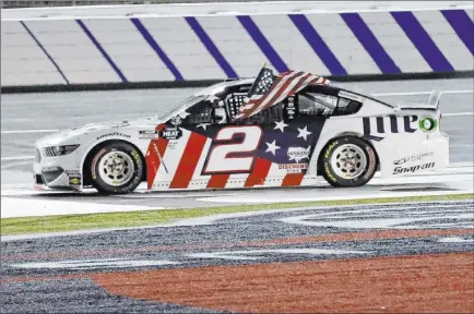  ?? Gerry Broome The Associated Press ?? Brad Keselowski waves the U.S. flag after winning the NASCAR Cup Coca-cola 600 early Monday at Charlotte (N.C.) Motor Speedway.