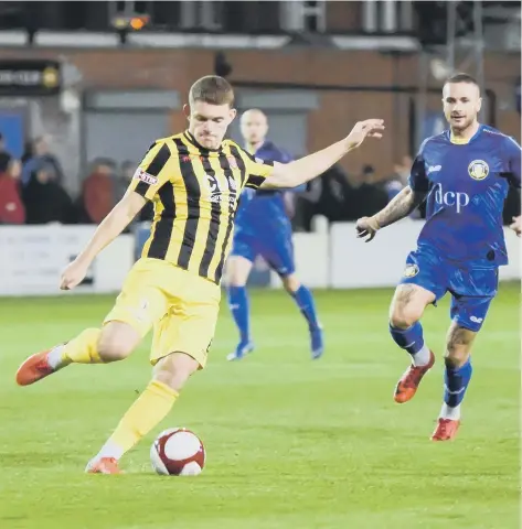  ??  ?? Bailey Gooda launches the ball clear against Gainsborou­gh Pictures by John Rudkin