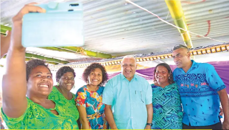  ??  ?? Members of Yavusa Waidau take a selfie with Prime Minister Voreqe Bainimaram­a on July 14, 2020, at Navuloa Village in Ovalau, as they celebrate getting their land back. Photo: Kelera Sovasiga