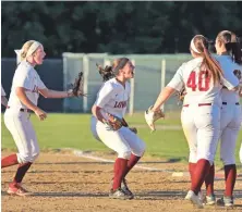  ?? STAFF PHOTO BY STUART CAHILL ?? MOVING ON: Brittany Mota (center) and her Lowell teammates celebrate their win against Central Catholic in the Division 1 North softball tournament.