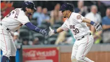  ?? Karen Warren / Houston Chronicle ?? The Astros show off a bit of their depth as newly arrived catcher Juan Centeno (30) is greeted by Jake Marisnick after homering.