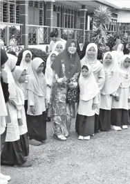  ??  ?? SALAH seorang guru wanita yang menerima sekuntum bunga sebagai tanda penghargaa­n dan terima kasih daripada murid-murid.