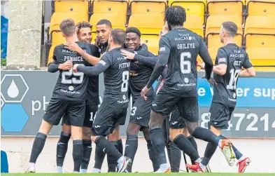  ?? ?? Livingston players get together to celebrate Odin Bailey’s opening goal