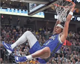  ?? ROB GRAY/USA TODAY SPORTS ?? Magic forward Paolo Banchero dunks the ball against the Jazz in the second quarter on Thursday in Salt Lake City.