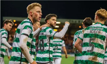  ?? Photograph: Vagelis Georgariou/Action Plus/ Shuttersto­ck ?? Mikey Johnston celebrates with teammates after scoring Celtic’s second goal at Dens Park.