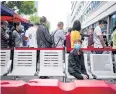  ??  ?? ONE AT A TIME: People stand in a queue for testing in Wuhan yesterday.