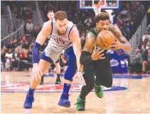  ?? TIM FULLER-USA TODAY SPORTS ?? DETROIT PISTONS forward Blake Griffin (left) and Boston Celtics guard Marcus Smart battle for the ball during the fourth quarter at Little Caesars Arena.