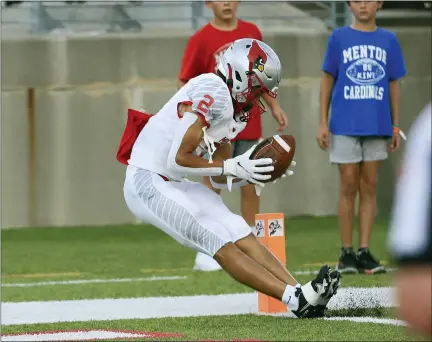  ?? TIM PHILLIS — FOR THE NEWS-HERALD ?? Mentor’s Michael Norwood drags his feet for a touchdown catch Aug. 21at Canton McKinley.