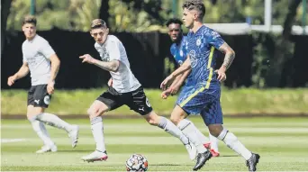  ??  ?? Posh midfielder Kyle Barker chases Chelsea star Christian Pulisic.