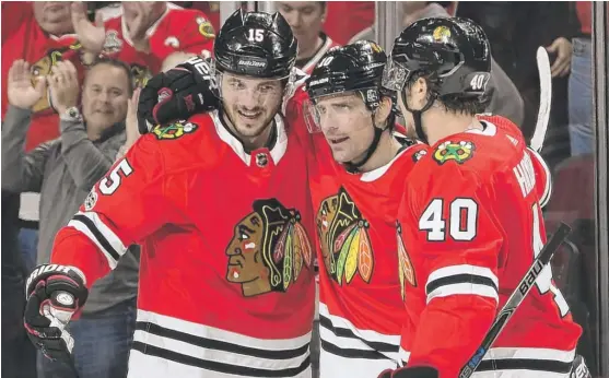  ?? | BILL SMITH/ GETTY IMAGES ?? Patrick Sharp ( center) and Artem Anisimov ( left) could see their placement on the third line as a demotion, but they have approached it with a positive attitude.