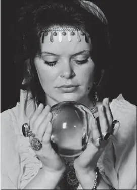  ?? DAILY EXPRESS — GETTY IMAGES ?? “Howie” Carrnac the Magnificen­t dusted off his crystal ball, like this one held by a fortune teller in 1971, and tells all he sees for the year ahead in news.